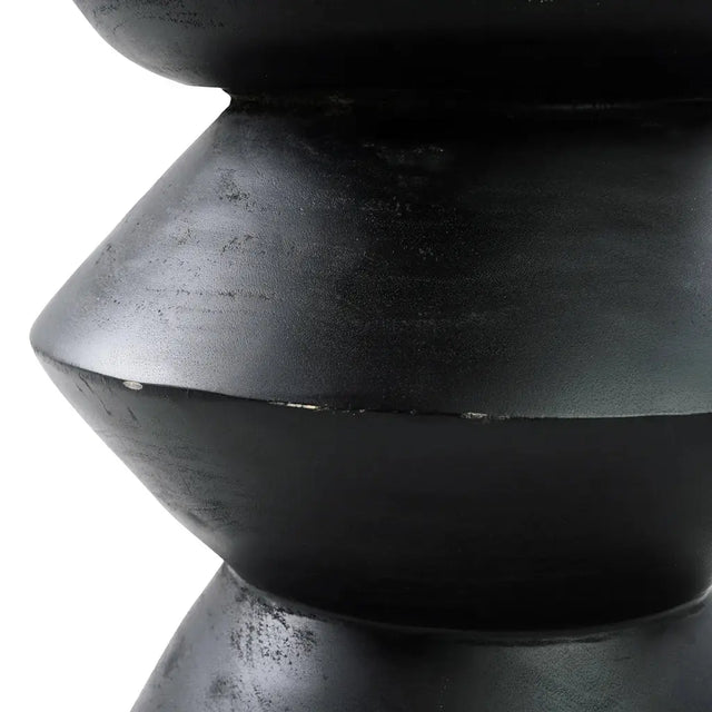 Enhance your decor with the Kulun Stool. Handcrafted from natural Suar wood and finished in sleek black, this modern piece adds elegance to any room.
