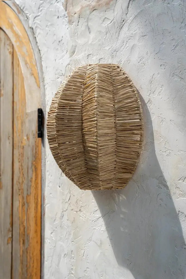 Unique raffia wall lamp, ideal for corridors and corners, with a soft, ambient glow and artistic design that enhances your home décor.