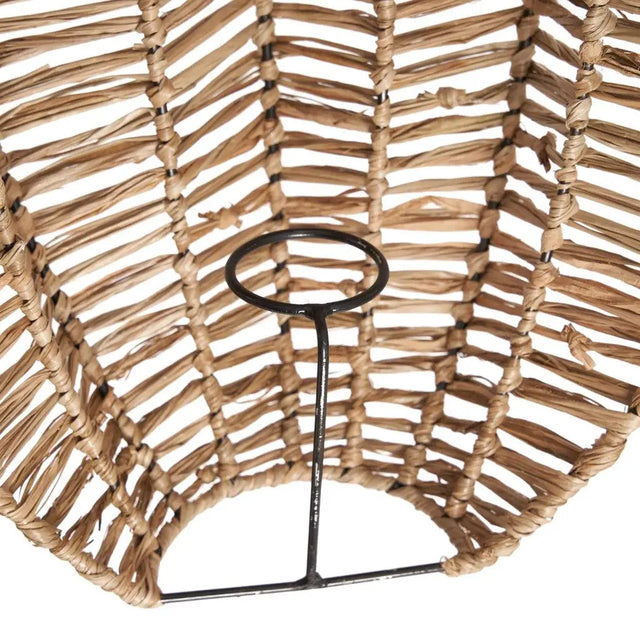 Beautiful wall lamp made of raffia, creating soft light patterns and adding a touch of bohemian charm to any room.