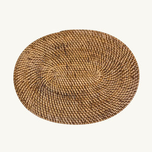 Natural brown handwoven rattan placemat, adding a tropical island touch to your table setting with its elegant oval design.