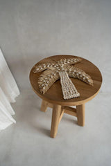 Close-up of the Atziri Stool's smooth teak wood grain, showcasing its natural finish and artisanal craftsmanship.