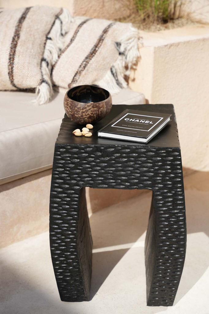 Black wooden stool, a versatile decor piece for modern and rustic interiors