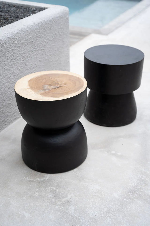 Carbon Crow Stool in a stylish bedroom, serving as a chic bedside table with a refined natural look