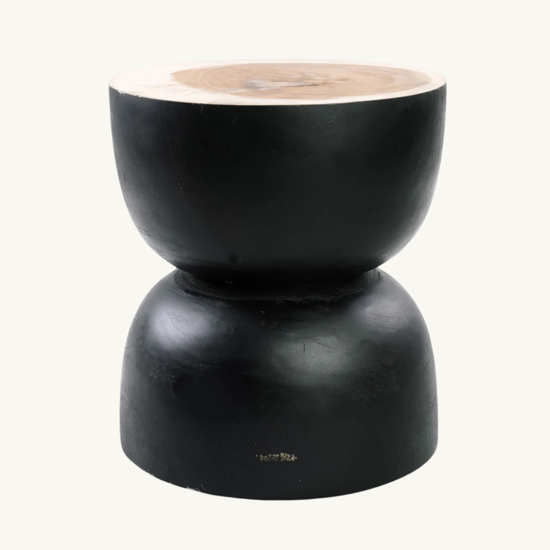 Carbon Crow Stool placed in a modern living room, adding a refined touch with its glossy black finish and sleek design