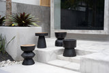Carbon Crow Stool placed in a covered outdoor area, adding sophistication with its elegant black finish and versatile design