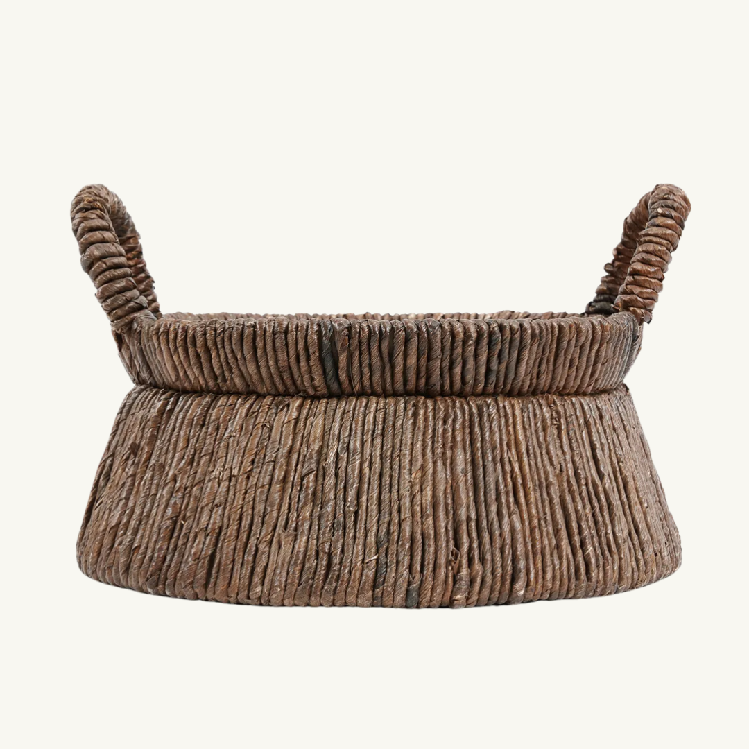 Chizara Mand Basket in a modern living room setting, showcasing its natural banana leaf material and triangular design for stylish storage.