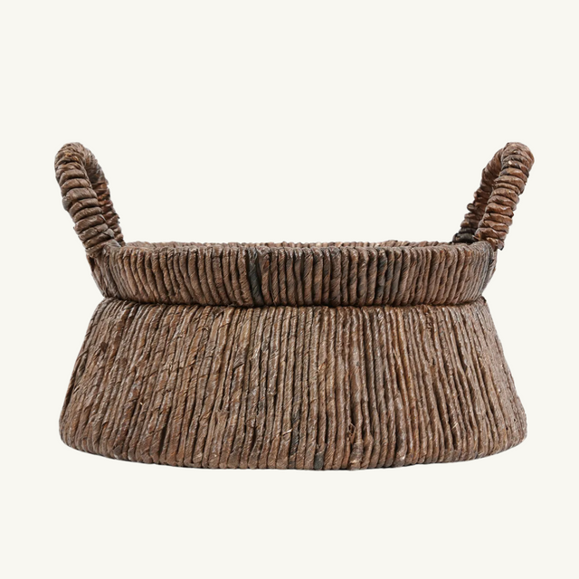 Chizara Mand Basket in a modern living room setting, showcasing its natural banana leaf material and triangular design for stylish storage.