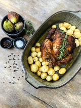 Green ceramic baking dish with speckled craquelure glaze from the Comporta Collection, ideal for both baking and serving.