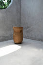 Ezili Stool made from natural suar wood with organic curves and geometric patterns, perfect as seating or a side table.