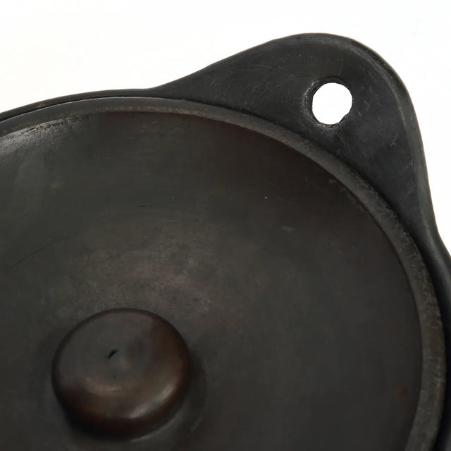 Durable and food-safe black burnt terracotta serving pot, conveniently dishwasher-safe for easy cleaning