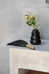 Versatile handcrafted Indonesian grass broom, perfect for cleaning both indoors and outdoors with a bohemian touch