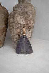 Natural black handcrafted Indonesian grass broom, blending functionality with aesthetic appeal for your home