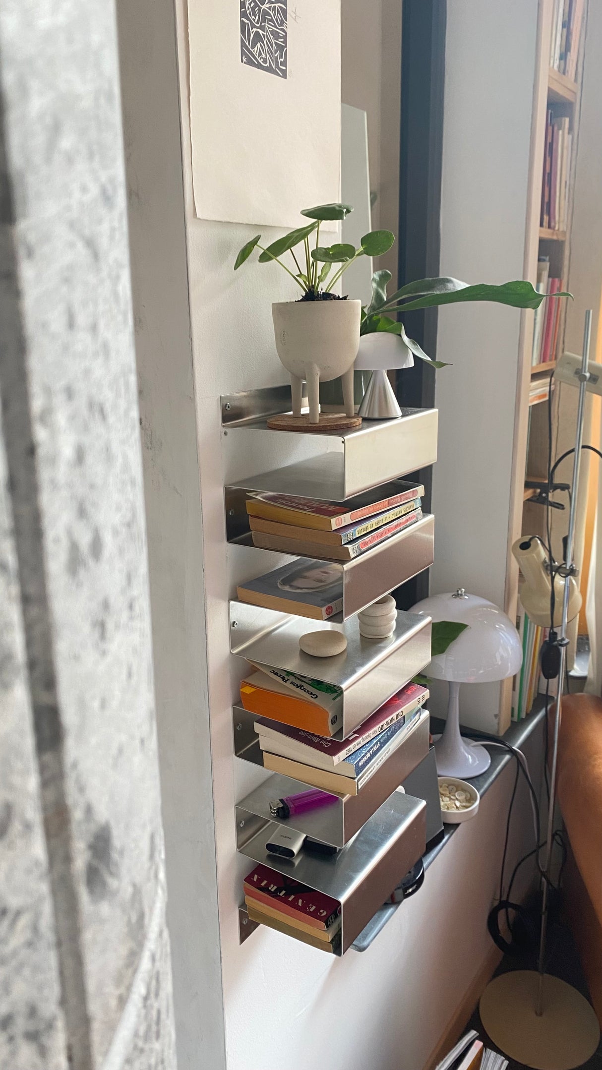 Close-up of the "1020G7" Mural Shelf showing aluminium finish and subtle surface scratches