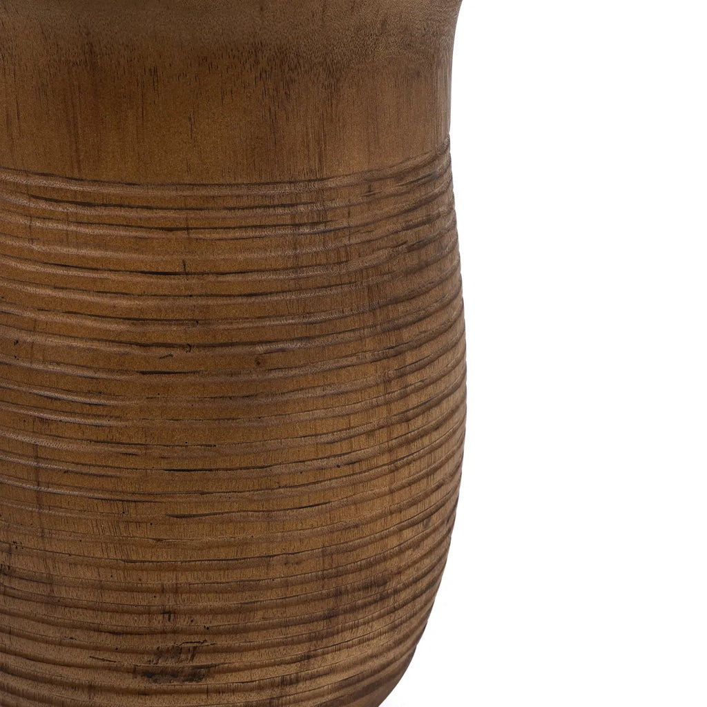 Ezili Stool crafted from suar wood, showcasing unique markings and stains that highlight the natural beauty of the material.